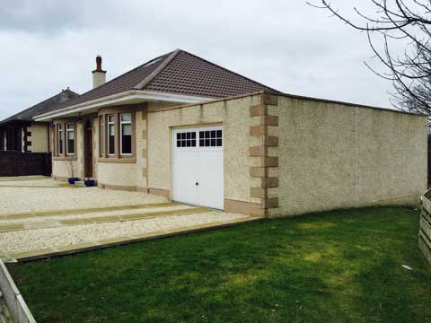 Side on view of house with brown roof, tiled roofing